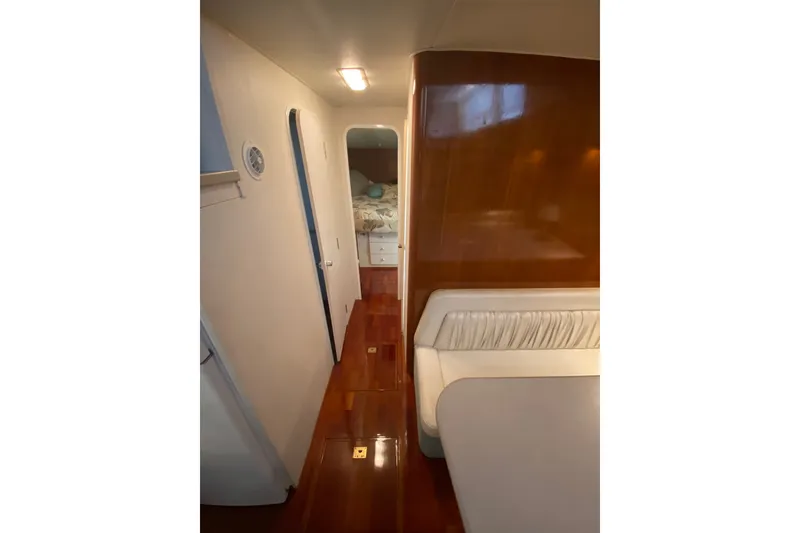Slide: The Image of Interior of a 1995 Silverton 41 Convertible yacht with polished wood flooring. - 17