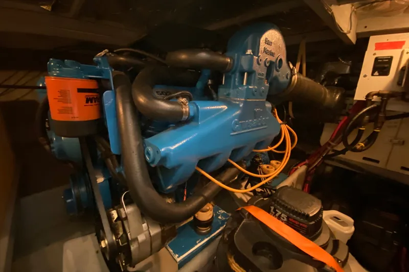 Slide: The Image of Engine room of a 1995 Silverton 41 Convertible boat, showcasing a blue marine engine. - 23