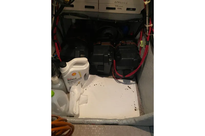 Slide: The Image of Engine compartment of a 1995 Silverton 41 Convertible with batteries and oil container. - 27