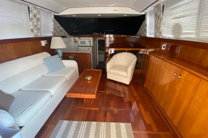 Slide: The Image of Luxurious interior of a 1995 Silverton 41 Convertible yacht with elegant wood finishes. - 9