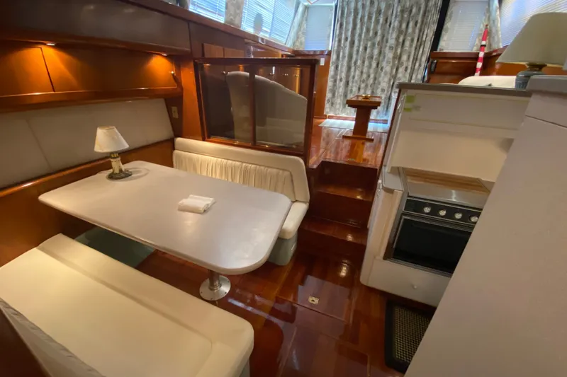 Slide: The Image of Interior of 1995 Silverton 41 Convertible yacht with dining area and kitchen. - 16