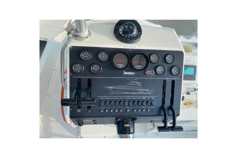 Slide: The Image of Control panel of a 1995 Silverton 41 Convertible boat with gauges and switches. - 4