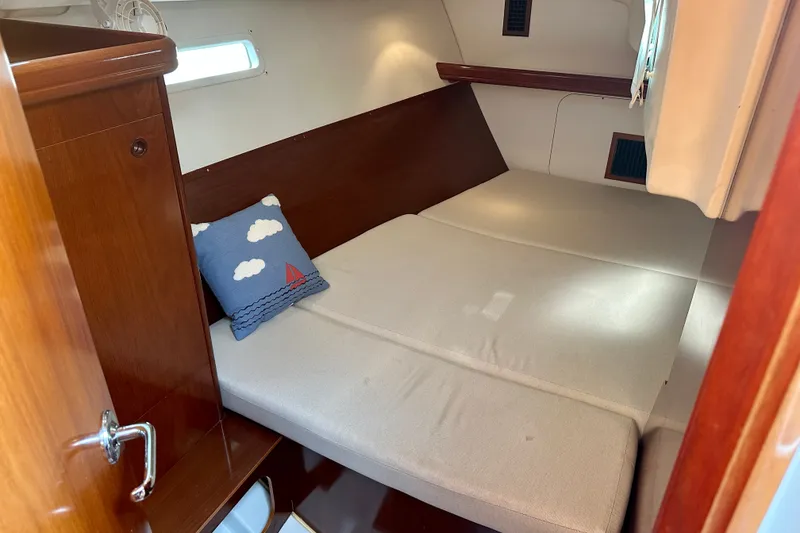 Slide: The Image of Cozy cabin interior of 2004 Beneteau Oceanis Clipper 393 sailboat with nautical-themed pillow. - 20