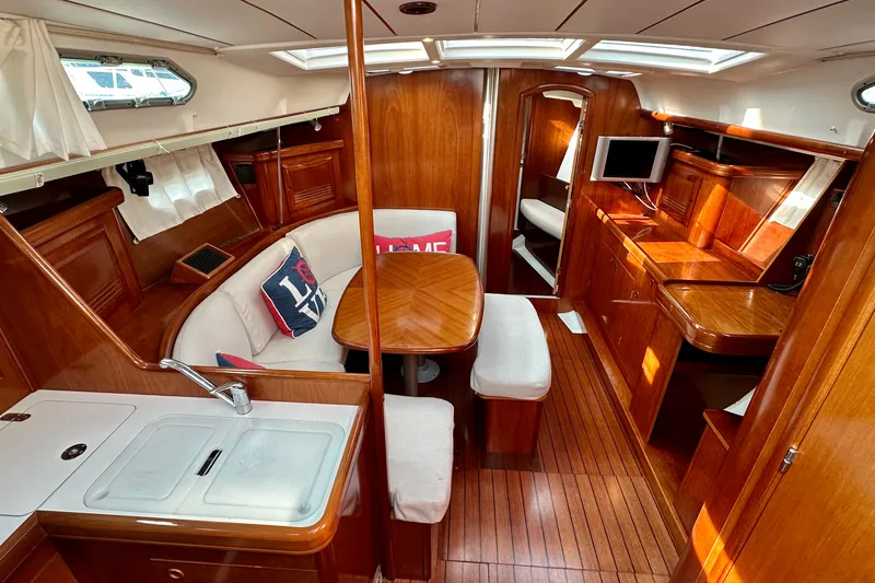 Slide: The Image of Luxurious interior of 2004 Beneteau Oceanis Clipper 393 yacht with wood finish and seating area. - 15