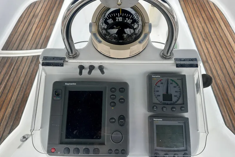 Slide: The Image of Beneteau Oceanis Clipper 393 cockpit instruments, featuring compass and Raymarine navigation displays. - 9