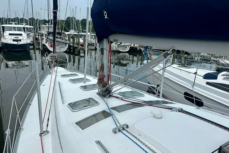 Slide: The Image of 2004 Beneteau Oceanis Clipper 393 sailboat docked at a marina, surrounded by other boats. - 12