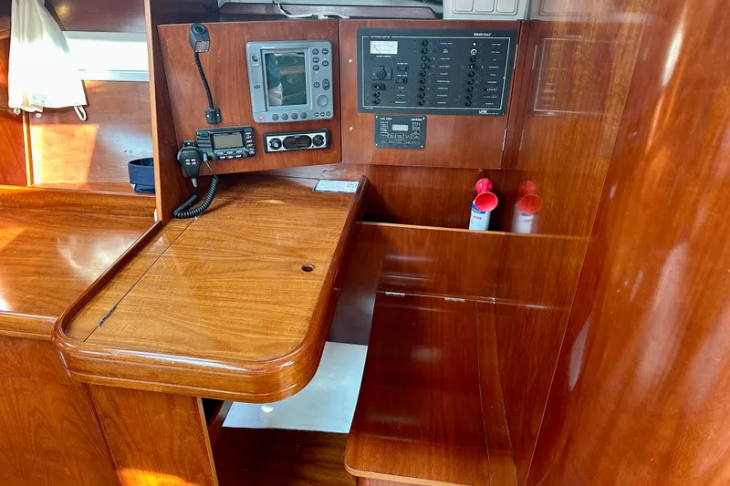Slide: The Image of Navigation station of 2004 Beneteau Oceanis Clipper 393 yacht with control panels and radio. - 19