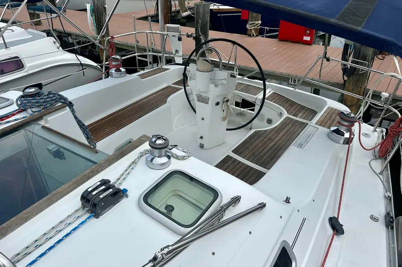 Slide: The Image of Cockpit of 2004 Beneteau Oceanis Clipper 393 sailboat with steering wheel and winches. - 6