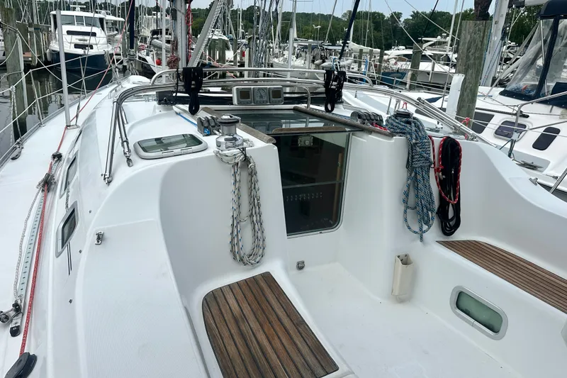 Slide: The Image of 2004 Beneteau Oceanis Clipper 393 sailboat cockpit with ropes and wooden seating. - 7