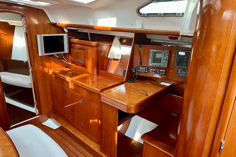 Slide: The Image of Interior of 2004 Beneteau Oceanis Clipper 393 yacht with wooden cabinetry and navigation equipment. - 17