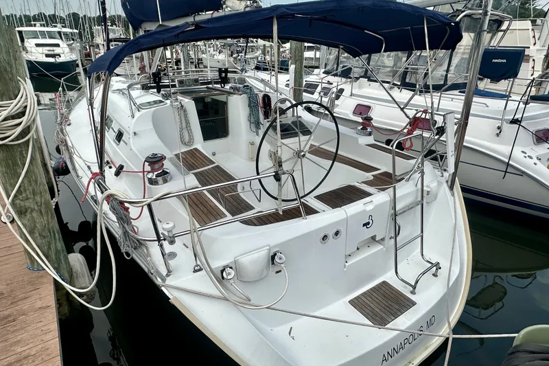 Slide: The Image of 2004 Beneteau Oceanis Clipper 393 sailboat docked in marina, featuring spacious cockpit and dual steering. - 3