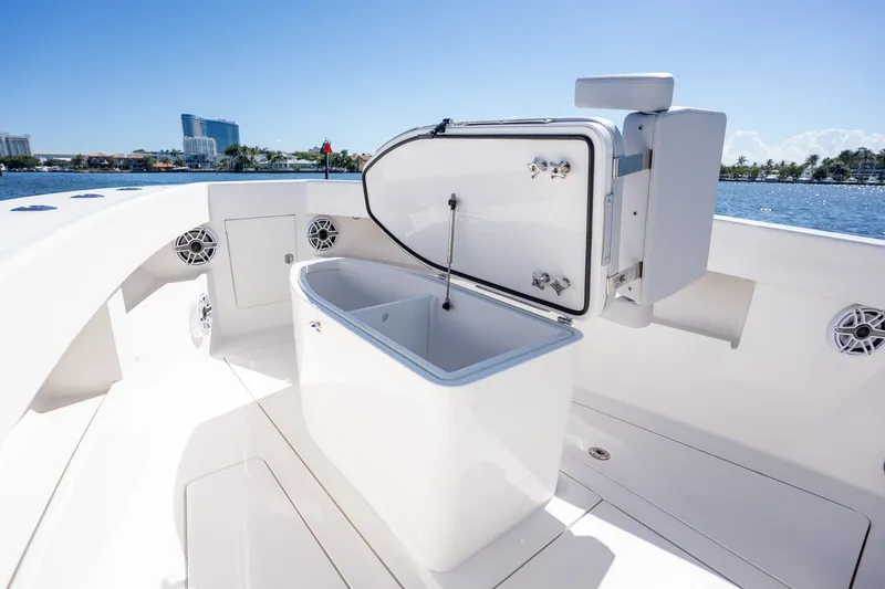 Slide: The Image of 2025 SeaVee 322Z boat with open storage compartment, sleek design, and waterfront view. - 16