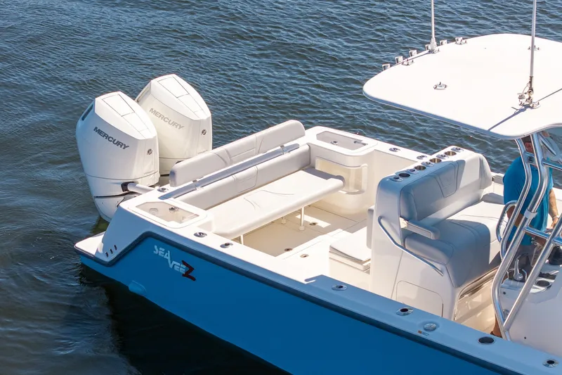 Slide: The Image of 2025 SeaVee 322Z boat with dual Mercury engines on calm water. - 8