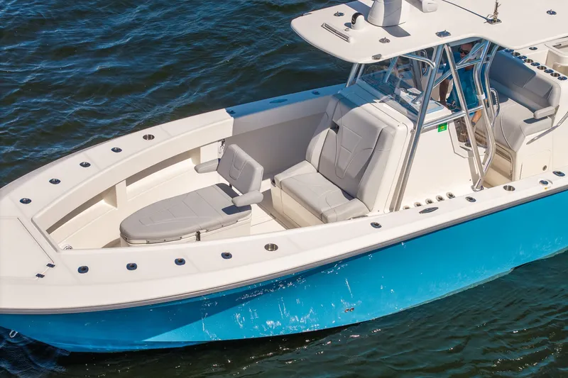 Slide: The Image of 2025 SeaVee 322Z boat with sleek design and spacious seating on the water. - 5