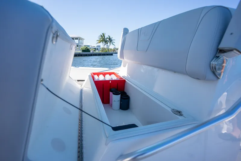 Slide: The Image of Storage compartment on 2025 SeaVee 322Z boat with drinks and binoculars. - 13
