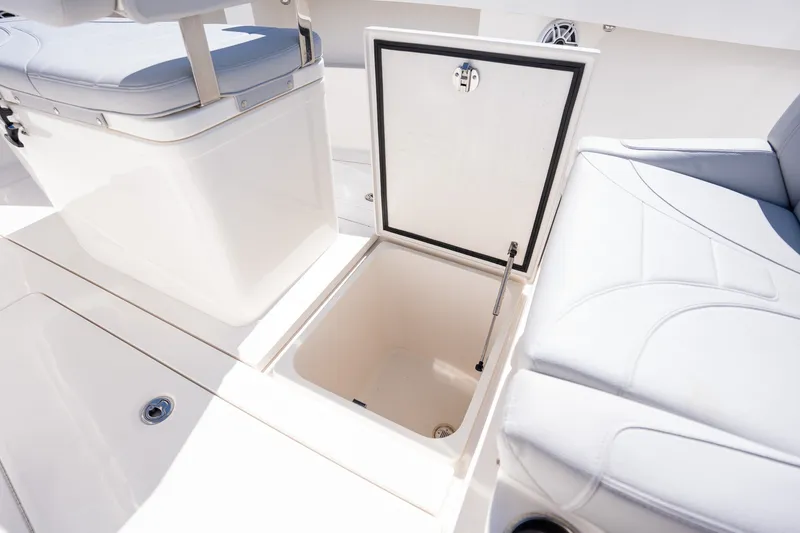 Slide: The Image of 2025 SeaVee 322Z boat with open storage compartment and cushioned seating. - 12