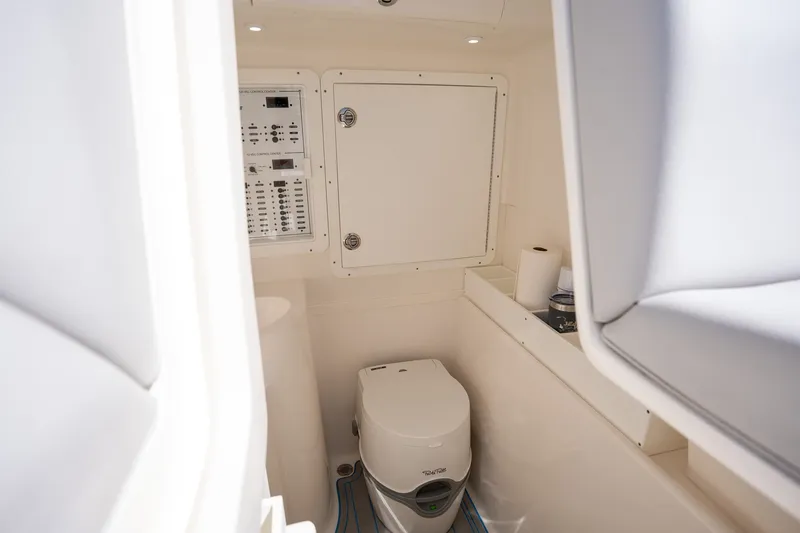Slide: The Image of Interior of 2025 SeaVee 322Z boat featuring a compact marine toilet. - 9