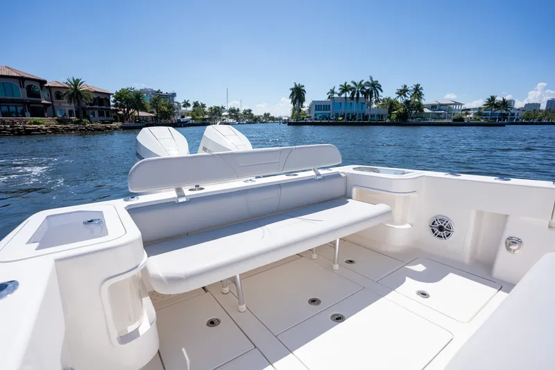 Slide: The Image of 2025 SeaVee 322Z boat interior with seating, on a sunny waterfront. - 7