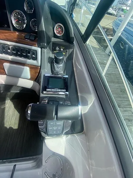 Slide: The Image of The cockpit of the 2018 Four Winns 355 Vista features modern controls and instruments. - 13