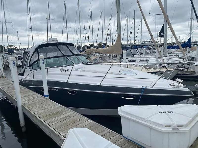Slide: The Image of A 2018 Four Winns 355 Vista docked at a marina, surrounded by other boats. - 5