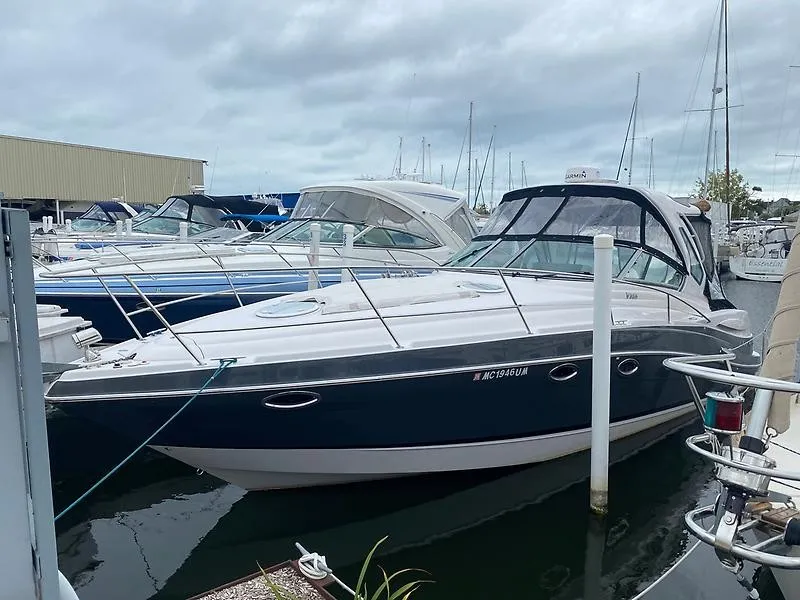 The Image of A 2018 Four Winns 355 Vista docked in a marina, surrounded by other boats. - 0