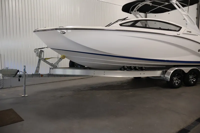 Slide: The Image of 2026 Yamaha Boats 275SE on trailer in indoor storage facility. - 49