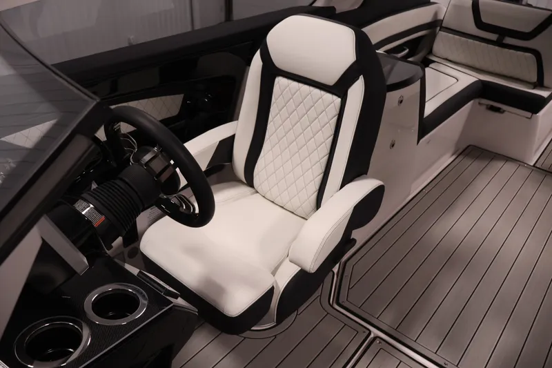 Slide: The Image of 2026 Yamaha Boats 275SE interior with luxurious seating and modern steering wheel design. - 24