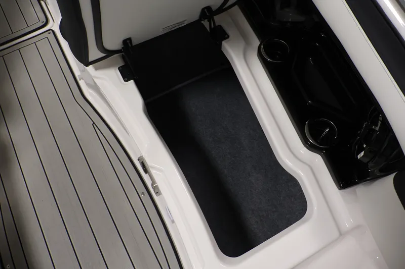 Slide: The Image of Interior view of 2026 Yamaha Boats 275SE, featuring sleek storage compartment and cup holders. - 13