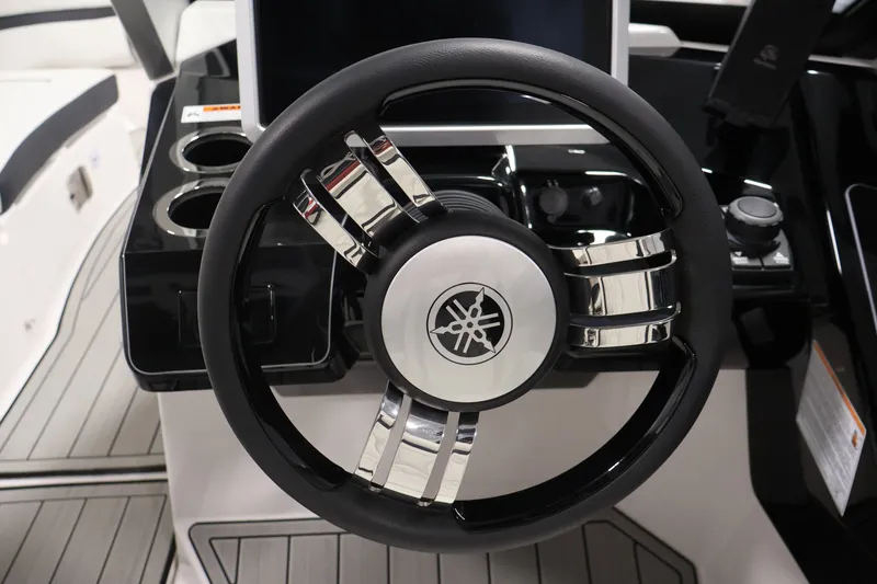Slide: The Image of Steering wheel of 2026 Yamaha Boats 275SE, featuring sleek chrome accents and modern design. - 19