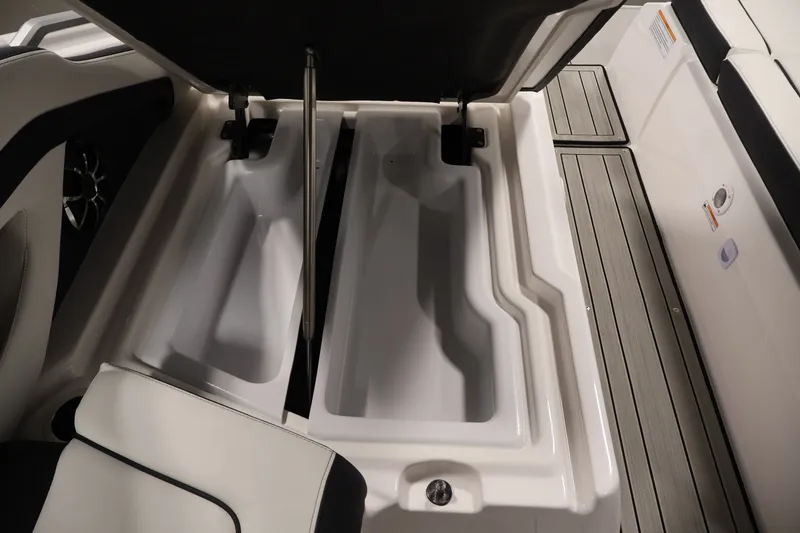 Slide: The Image of 2026 Yamaha Boats 275SE storage compartments with open lid, showcasing spacious interior design. - 37