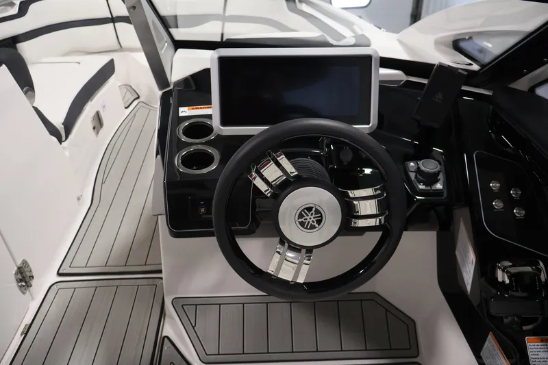 Slide: The Image of Interior of 2026 Yamaha Boats 275SE, featuring sleek steering wheel and modern dashboard. - 18