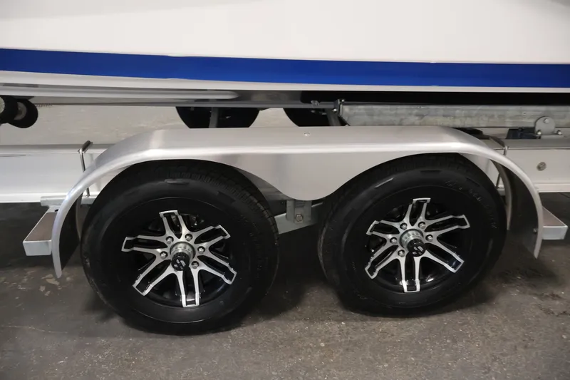 Slide: The Image of Trailer wheels of a 2026 Yamaha Boats 275SE, featuring sleek alloy rims. - 50