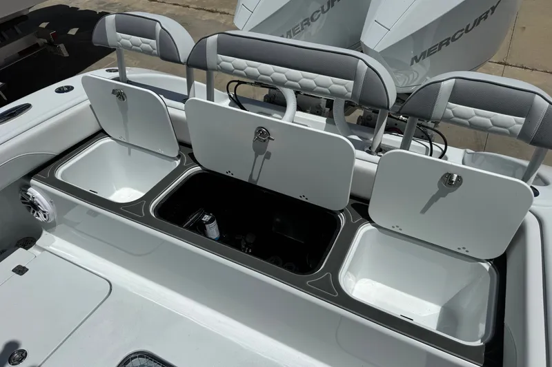 Slide: The Image of 2027 Yellowfin 26 Hybrid boat with open storage compartments and Mercury engines. - 25