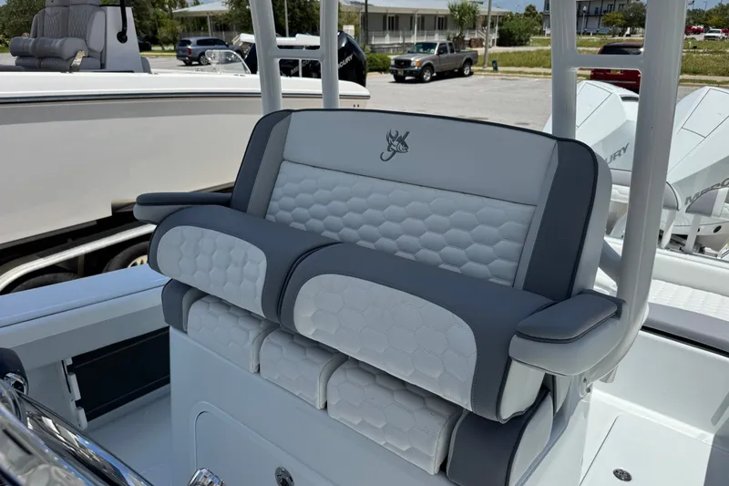 Slide: The Image of 2027 Yellowfin 26 Hybrid boat seat with hexagonal pattern and logo. - 19