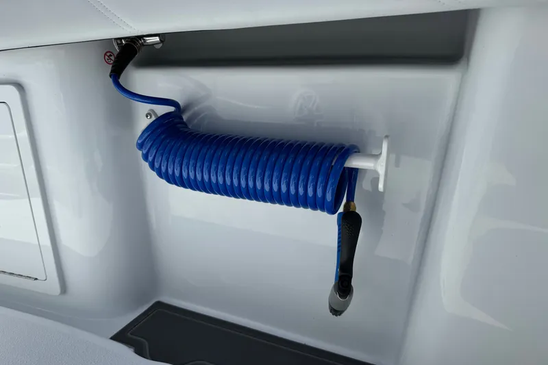 Slide: The Image of Blue coiled hose on 2027 Yellowfin 26 Hybrid boat, neatly mounted on white surface. - 14