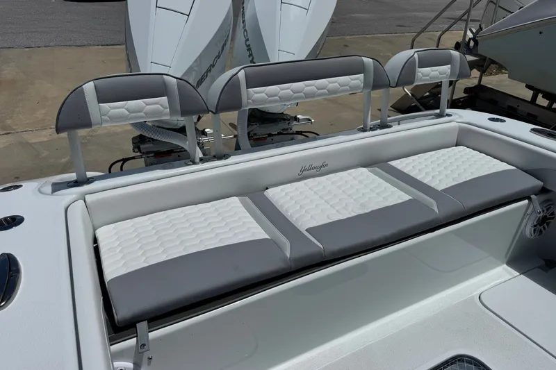 Slide: The Image of 2027 Yellowfin 26 Hybrid boat seating with gray and white cushioned design. - 23