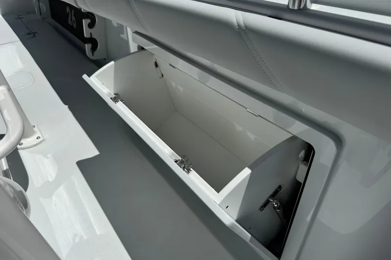 Slide: The Image of Open storage compartment on 2027 Yellowfin 26 Hybrid boat, showcasing interior space. - 16
