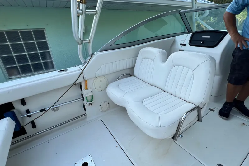 Slide: The Image of 2012 Robalo R247 Dual Console boat interior with white seating and dashboard. - 22