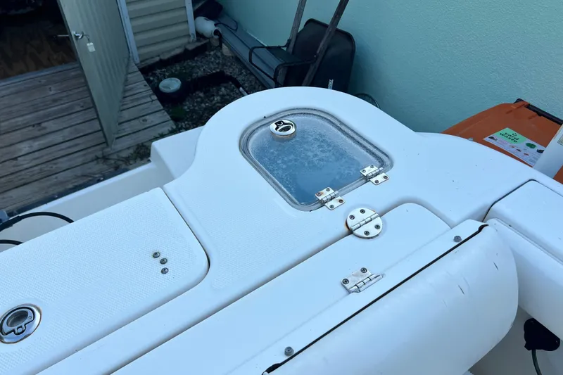 Slide: The Image of 2012 Robalo R247 Dual Console boat deck with storage compartments and hardware. - 35