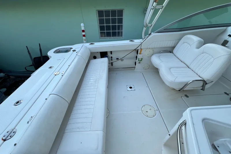 Slide: The Image of 2012 Robalo R247 Dual Console boat interior with white seating and spacious deck area. - 38