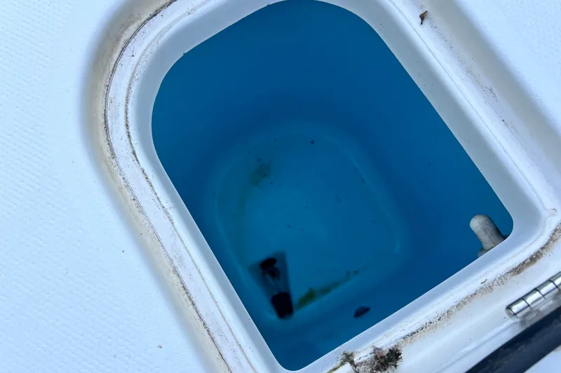Slide: The Image of Open storage compartment on 2012 Robalo R247 Dual Console boat. - 37