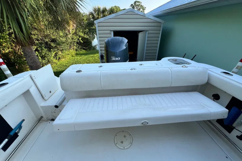 Slide: The Image of 2012 Robalo R247 Dual Console boat with Yamaha 300 engine, docked near greenery. - 34