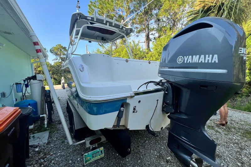 Slide: The Image of 2012 Robalo R247 Dual Console boat with Yamaha outboard motor, parked outdoors. - 10