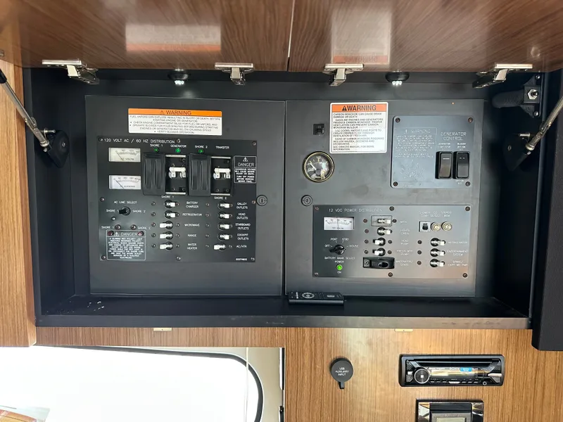 Slide: The Image of Electrical panel of a 2017 Cruisers Yachts 350 Express with switches and indicators. - 16