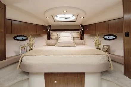 Slide: The Image of Luxurious bedroom with a large bed, wooden cabinetry, and a skylight in a yacht. - 38