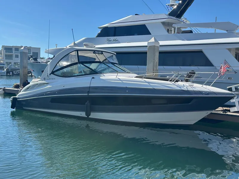 Slide: The Image of A 2017 Cruisers Yachts 350 Express is docked in the water beside a larger boat. - 30