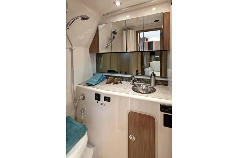 Slide: The Image of The image shows the bathroom of a 2017 Cruisers Yachts 350 Express with a sink and mirror. - 39