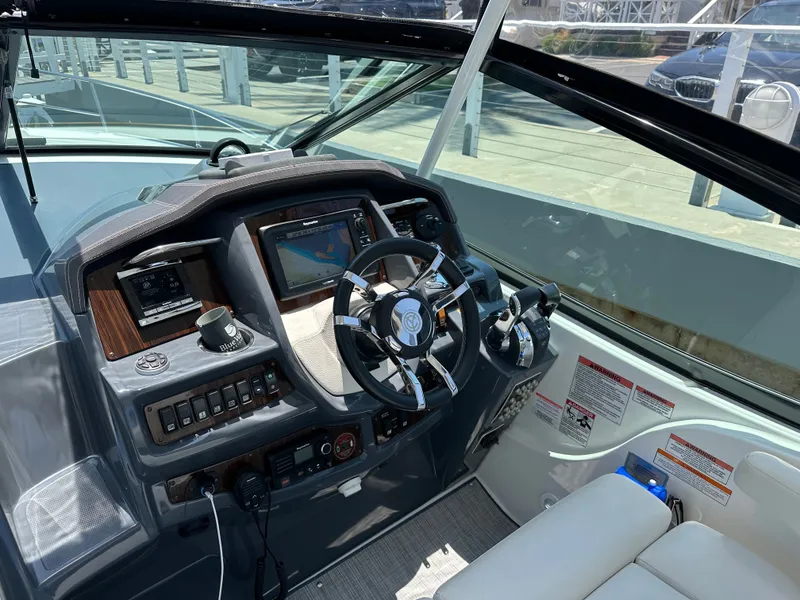 Slide: The Image of The image shows the helm of a 2017 Cruisers Yachts 350 Express with modern instruments. - 14