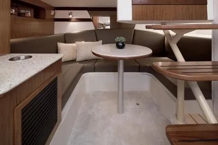Slide: The Image of Interior of the 2017 Cruisers Yachts 350 Express with seating area and table. - 37