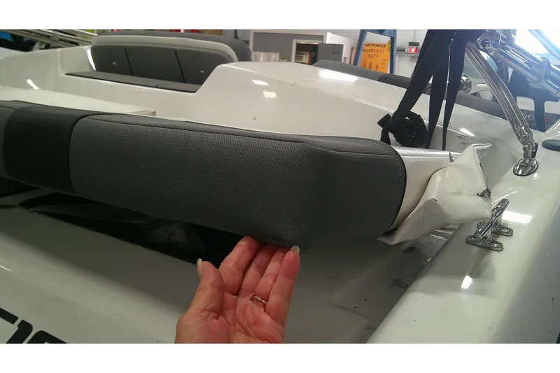 Slide: The Image of Close-up of a 2026 Tahoe T16 boat seat with hand inspecting upholstery. - 5